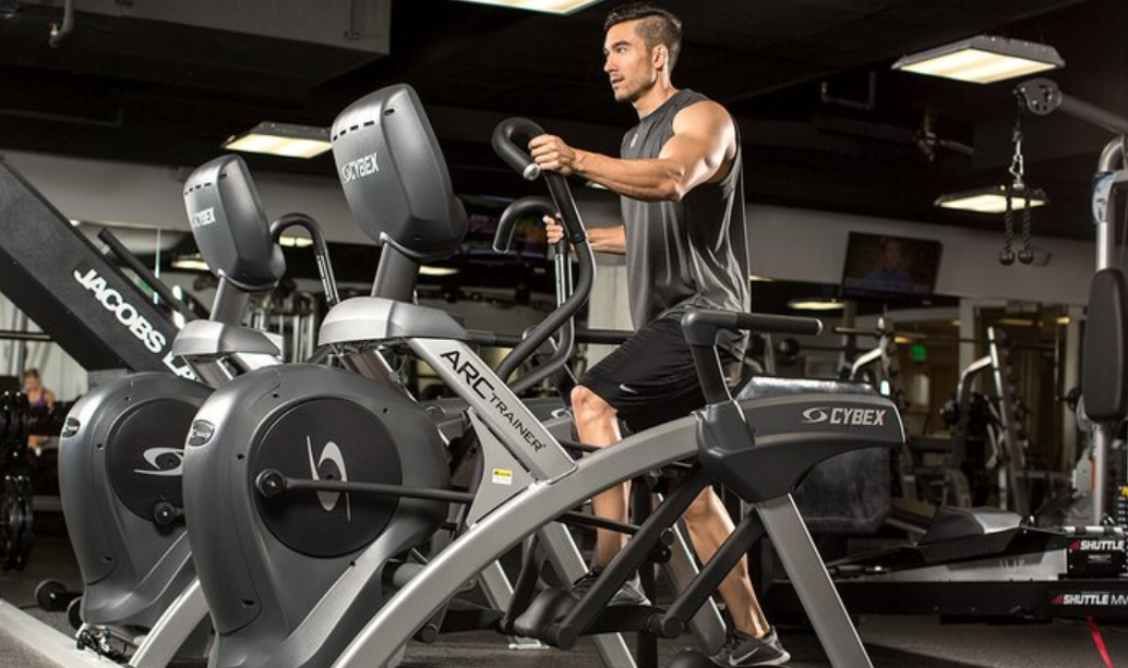 man wokring out in arc trainer machine